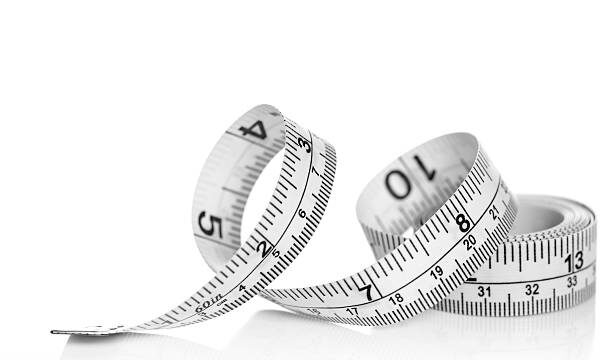 White tape measure on white background with reflectio